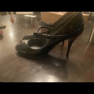 Stuart Weitzman patent leather Mary Jane peep toe pumps.